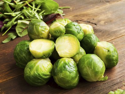 Fresh brussels sprouts on a chopping board.