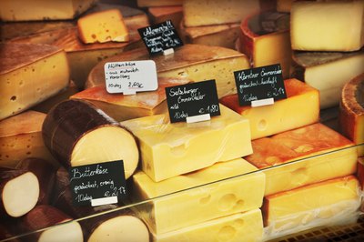 An assortment of cheeses at a deli counter