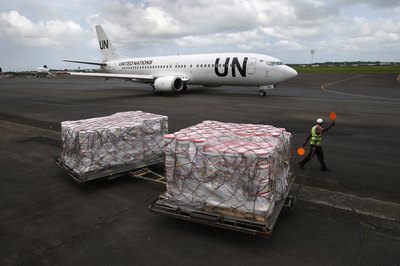 A government shipment is delivered at an airport.
