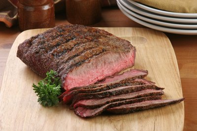 Sliced flank steak on cutting board.