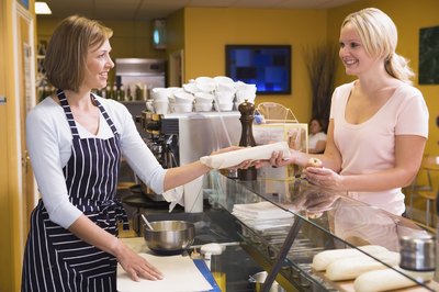 Deli employee with customer