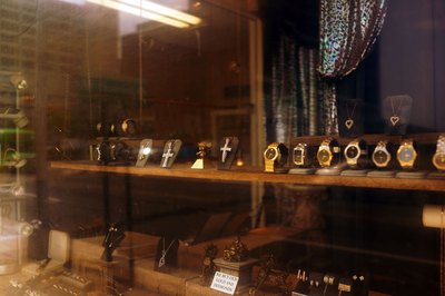 Valuables for sale in a pawn shop window.