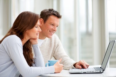 couple researching on computer
