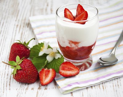 Small cup of yogurt with strawberries.