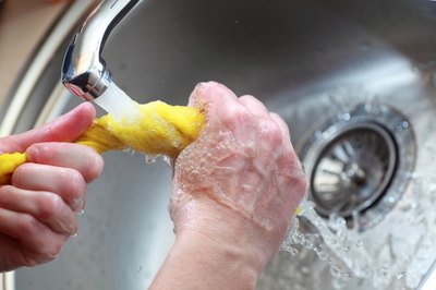 Hands wringing out wet cloth