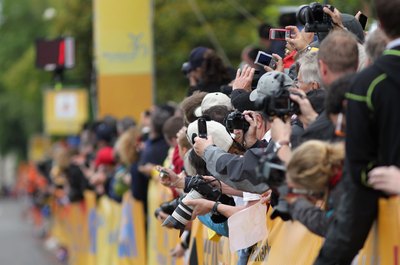Fans with cameras at bicycling event