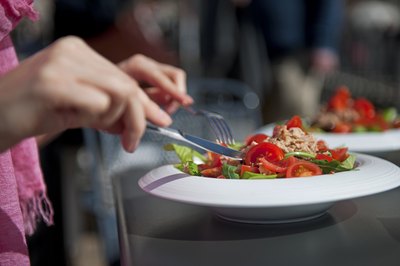 Woman eating a salad at a restaurant