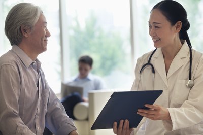 Doctor showing patient his health records.