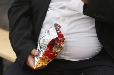 Man eating greasy snack food