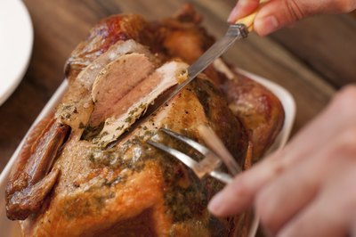 Trussing turkey allows it to cook evenly.