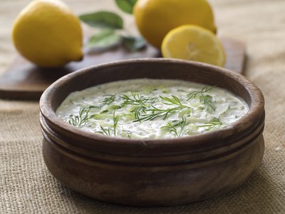 Bowl of tsatsiki dip and lemons