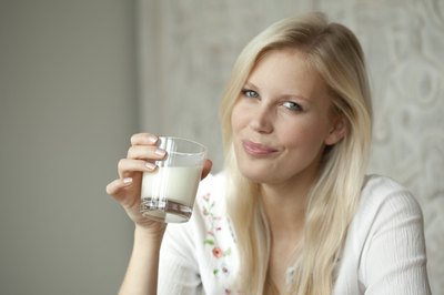 Woman drinking a glass of milk