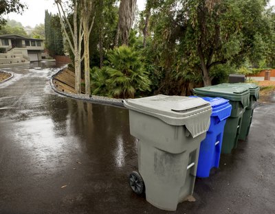 Compost and recycle bins on a suburban street.