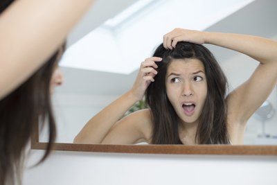 woman looking at hair roots