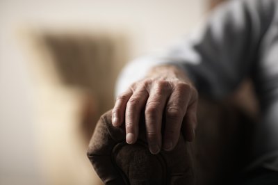 Man with hand on chair