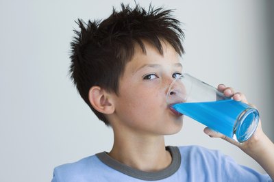 child drinking blue juice