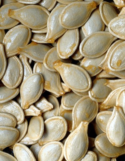 Colored pumpkin seeds are inexpensive game pieces for a fall party.