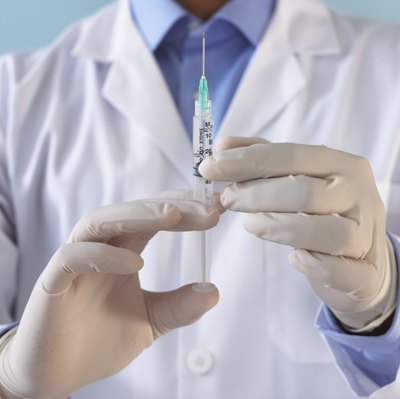 Doctor holding syringe