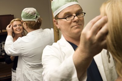 Doctor inspecting face of patient