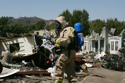 A man evaluates the levels of hazardous materials in a neighborhood after an earthquake.