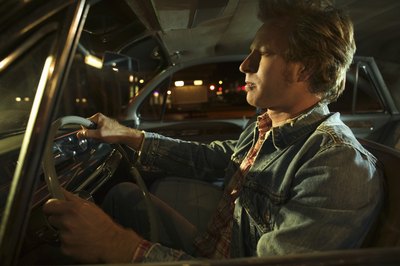 Man driving a car at night