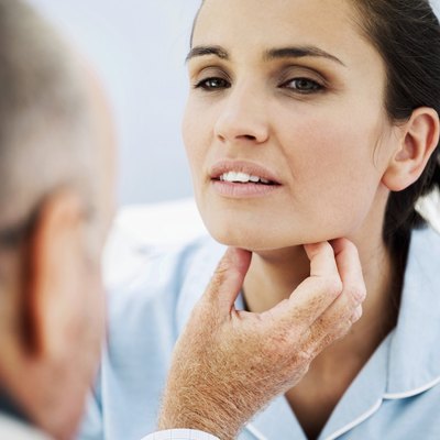A doctor checks a womans throat for obstructions..