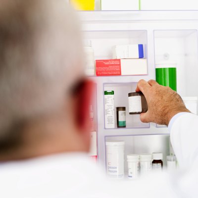 Man reaching for medication in cabinet