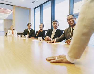 Manager addressing staff in meeting