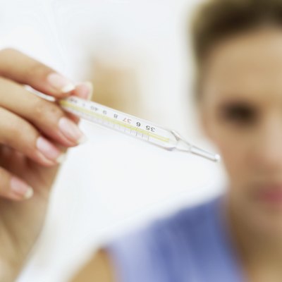 Woman taking her temperature