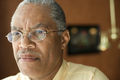 Senior man looking out window