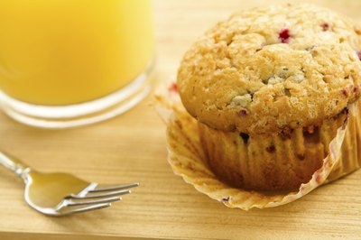 Muscadine muffin beside glass of orange juice