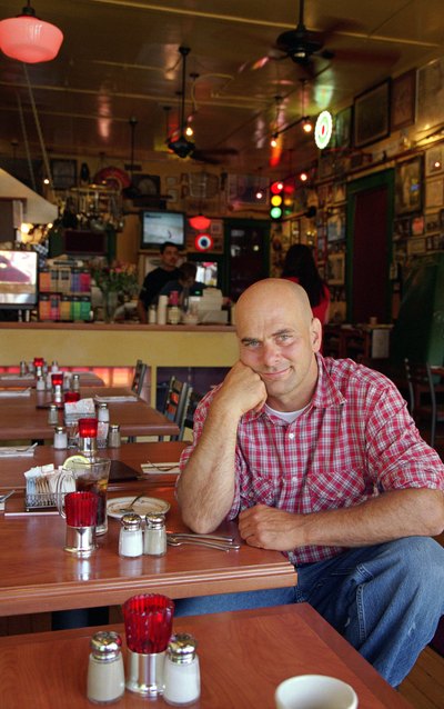 A customer sits at a table in a neighborhood coffeehouse.
