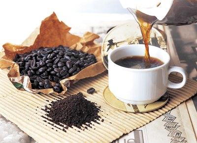 Coffee beans, ground coffee and a cup of coffee.