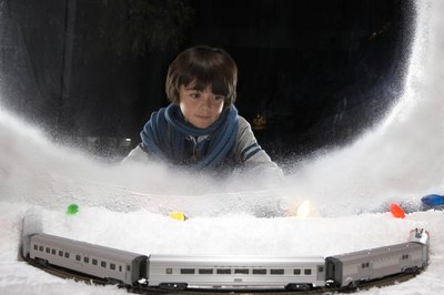 Young boy looking at train display in window