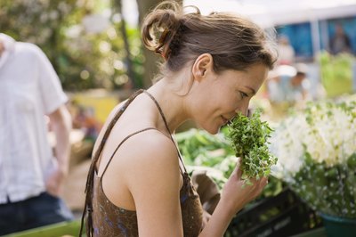 Woman smelling herbs