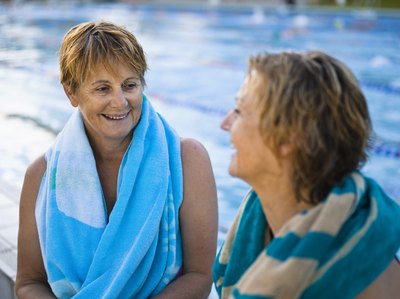 Two woman talking at pool