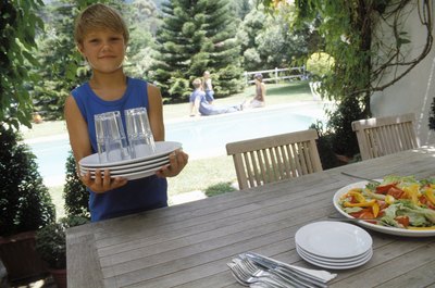 Boy setting table