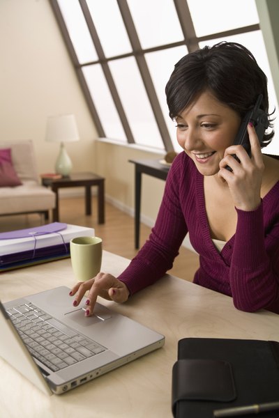 Woman on phone in front of computer