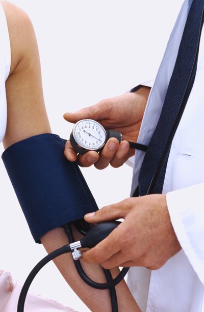 Doctor taking patients blood pressure