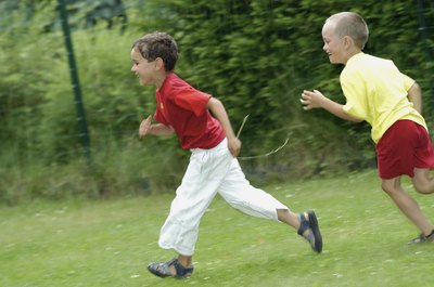 Boys running on grass.