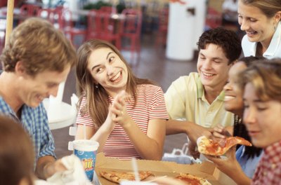 Teens eating pizza