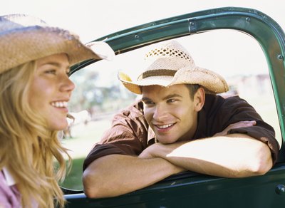Young woman wearing cowboy hat in truck