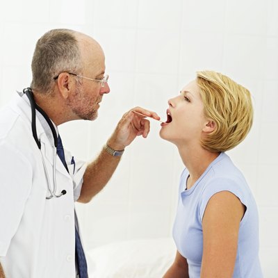 Doctor inspects a patient's mouth