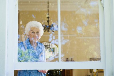 Senior woman looking out window