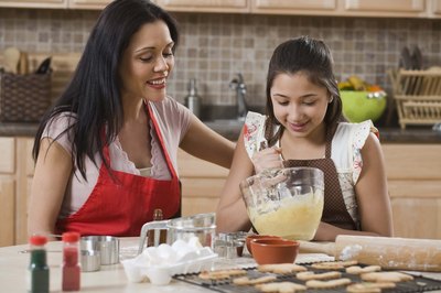 mother and daughter baking cookies