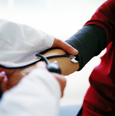 Doctor checking blood pressure