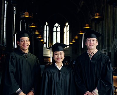 Three esteemed graduates wear white tassles.