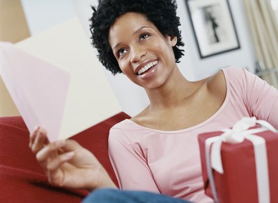 A woman receives a card and present.