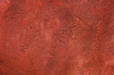 A close-up of a brick red textured wall.