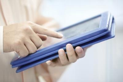 Man touches electronic tablet